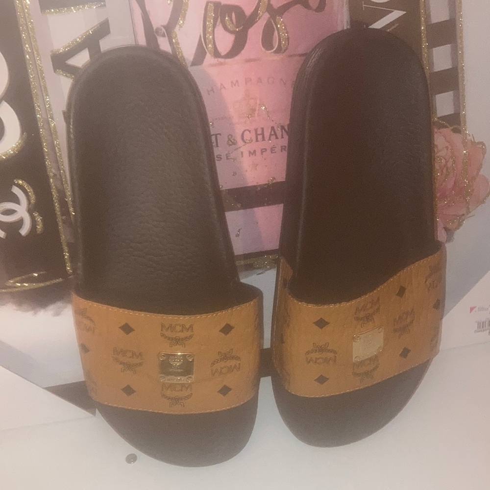 Cognac leather strap with gold logo plaque and rubber sole MCM sandal.